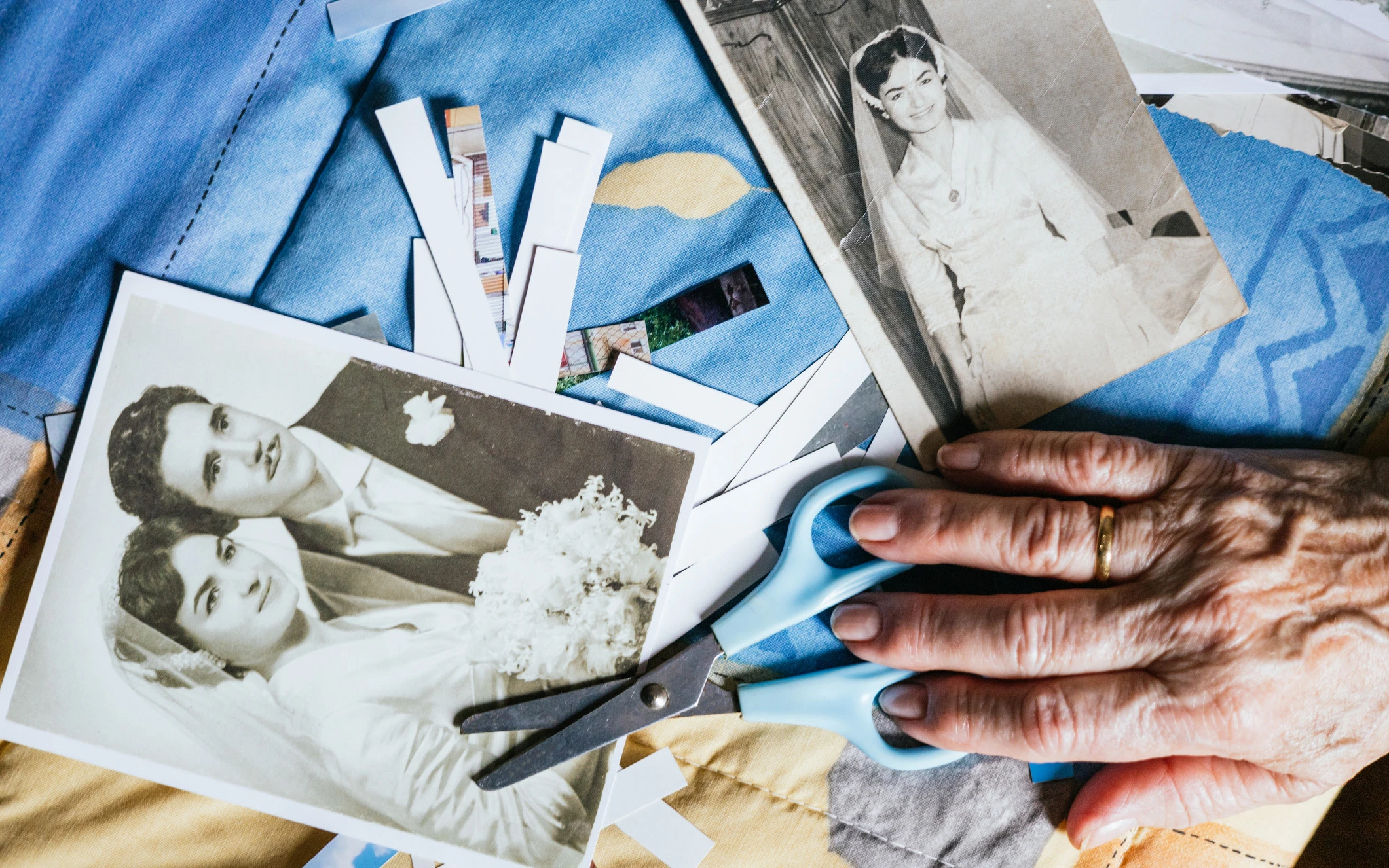 Elderly Hand Cutting Old Wedding Photos